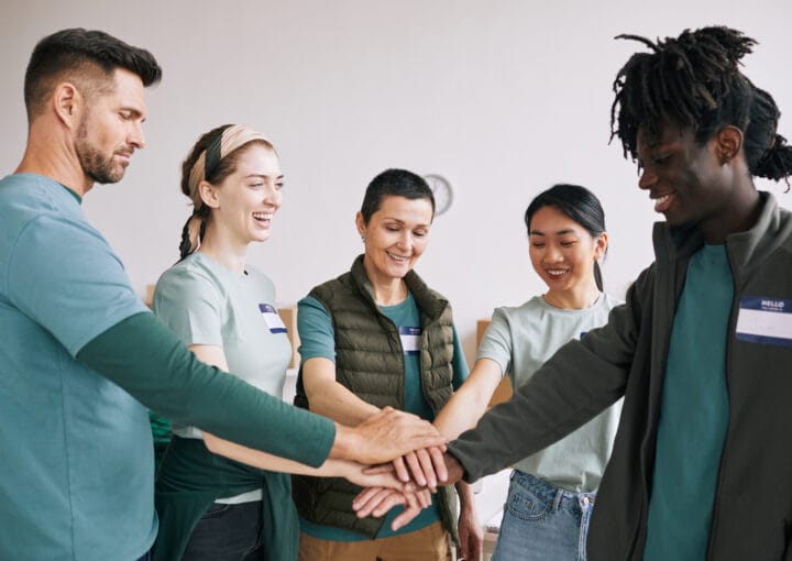 Coworkers stacking hands for teamwork