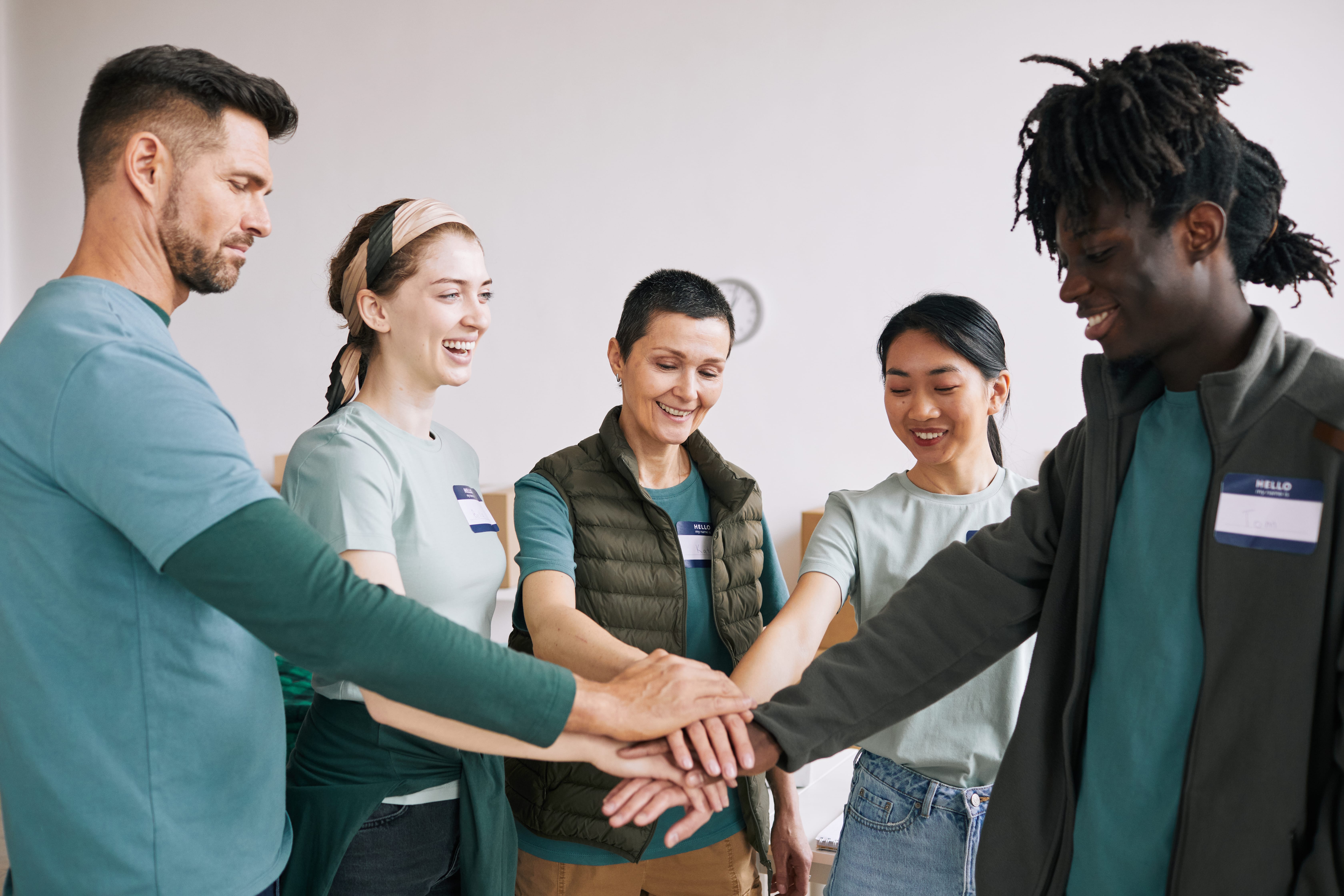 Coworkers stacking hands for teamwork