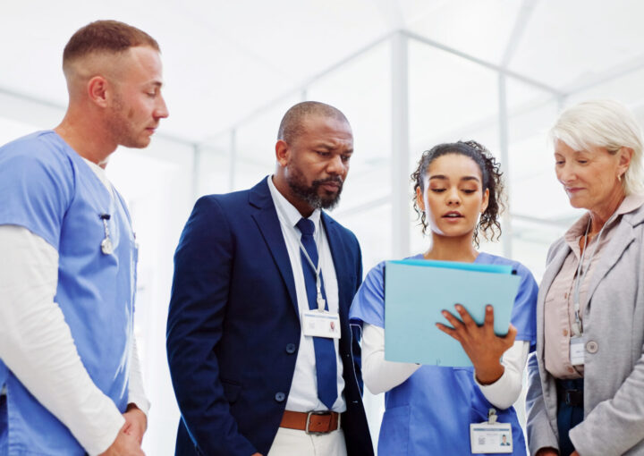 Doctors reviewing documents in a hospital meeting