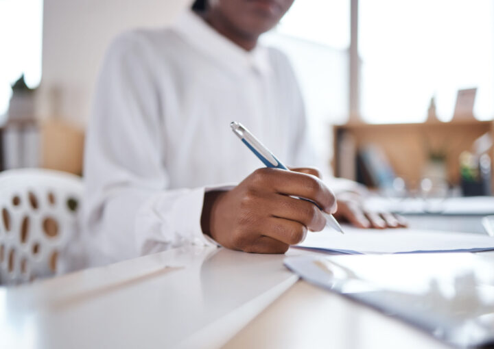 Businesswoman completing compliance paperwork